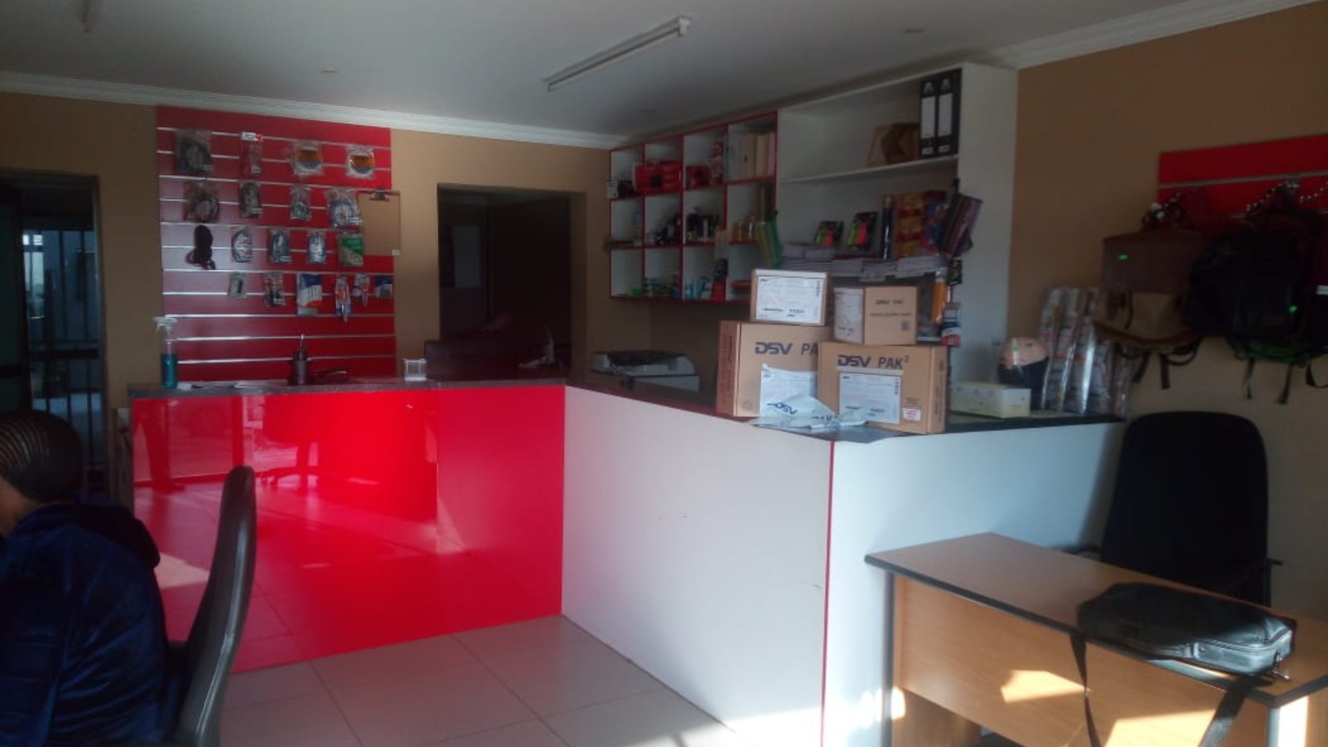 Merchant at a community shop counter